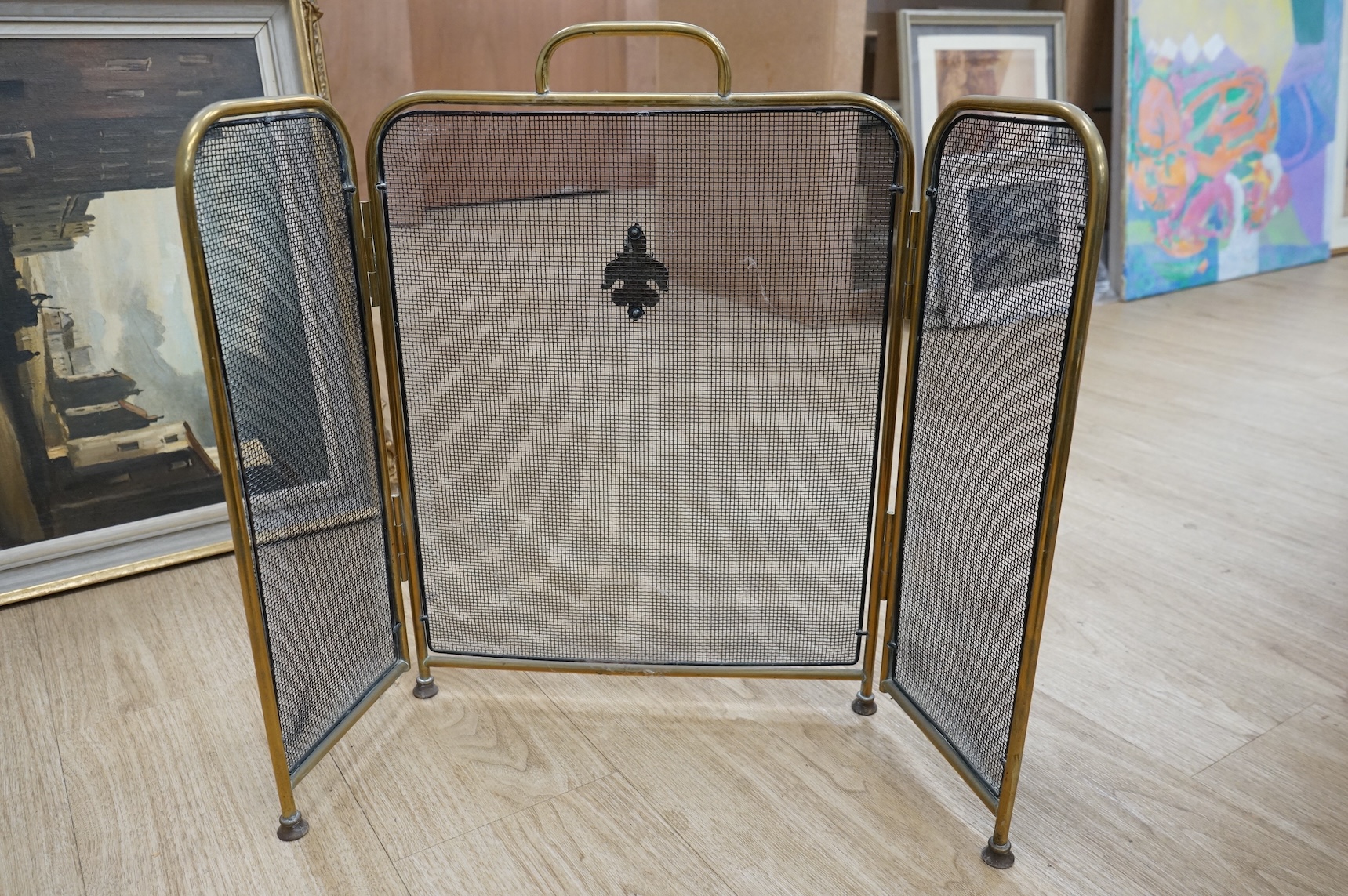 A fire brass guard, pair of candlesticks, kettle, miner's lamp etc, fire guard 54cm high.
